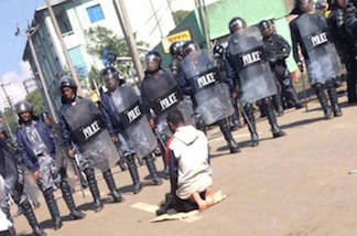 The Salat Man is a lone worshiper who was encircled by riot police
